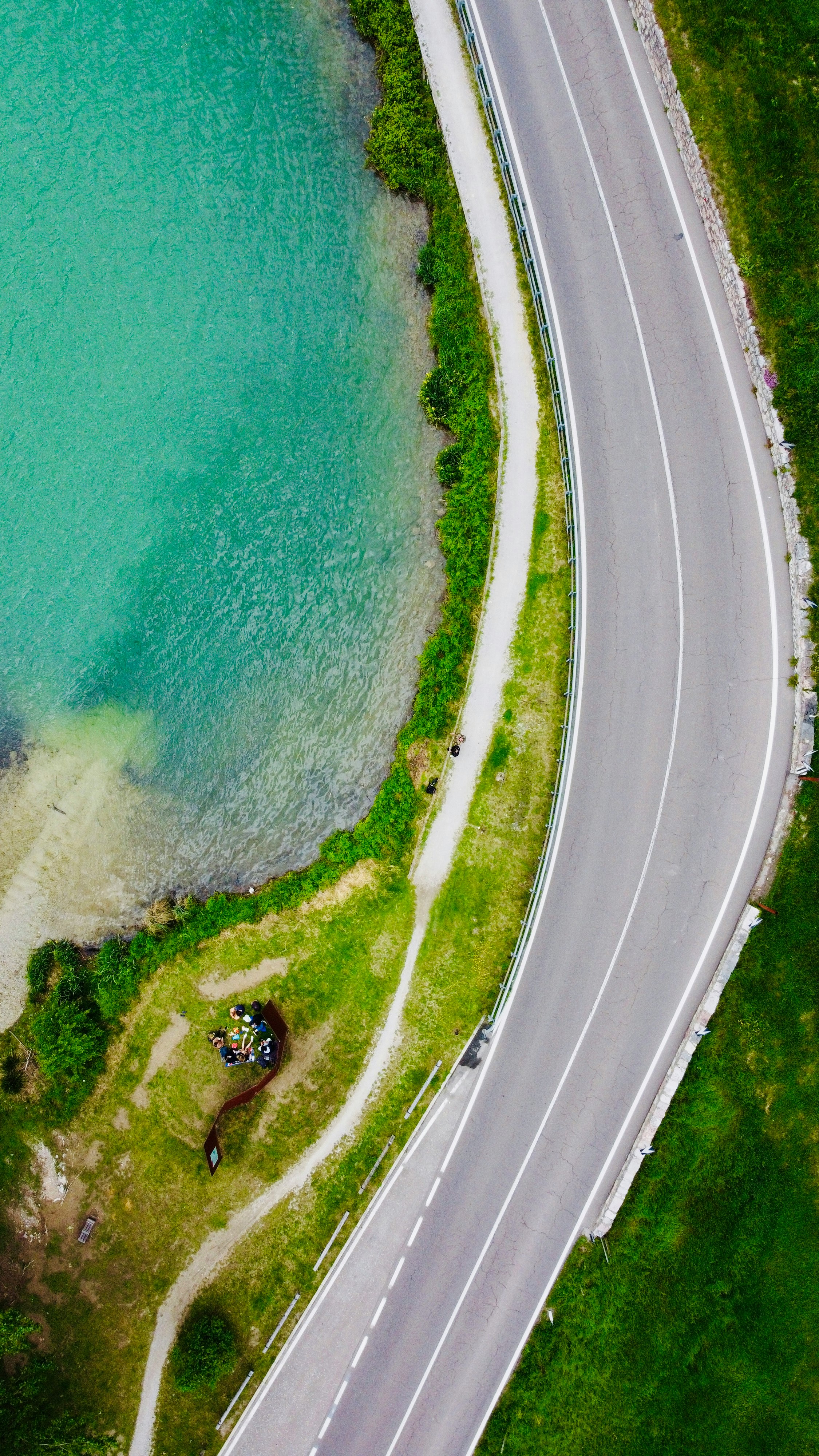 aerial view of road beside body of water during daytime